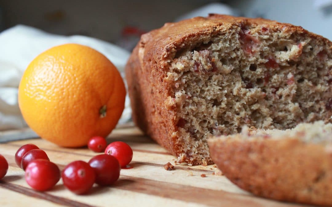 Cranberry Orange Bread with cranberries and an orange