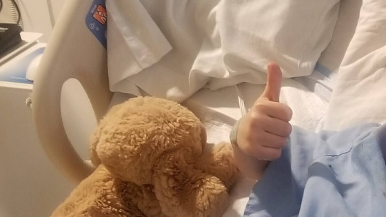 thumbs up sign from hospital bed